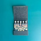 Inside of menorah matchbook depicting an illustration of the memorial with florals interwoven and the Star of David