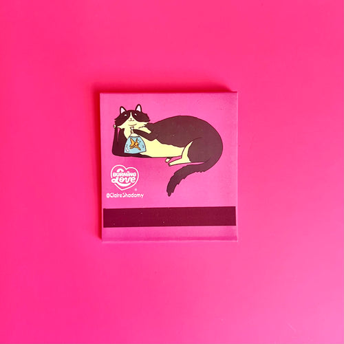 Back of cat matchbook showing a black-and-white cat lounging and the match-striking bar at the bottom