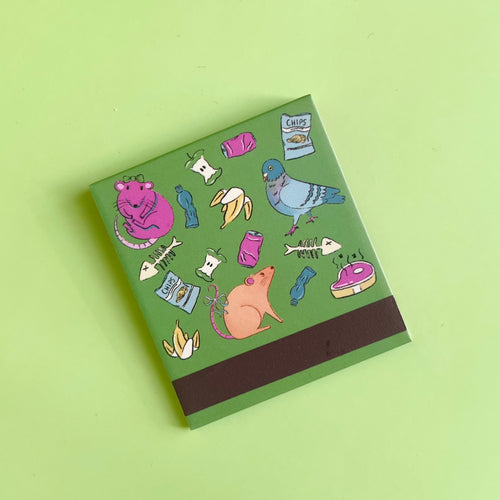Back of City Animals matchbook depicting animals and trash as illustrations with the match-striking bar on the bottom