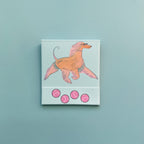 Front of dog matchbook featuring an illustration of an Afghan Hound with tennis balls on the bottom