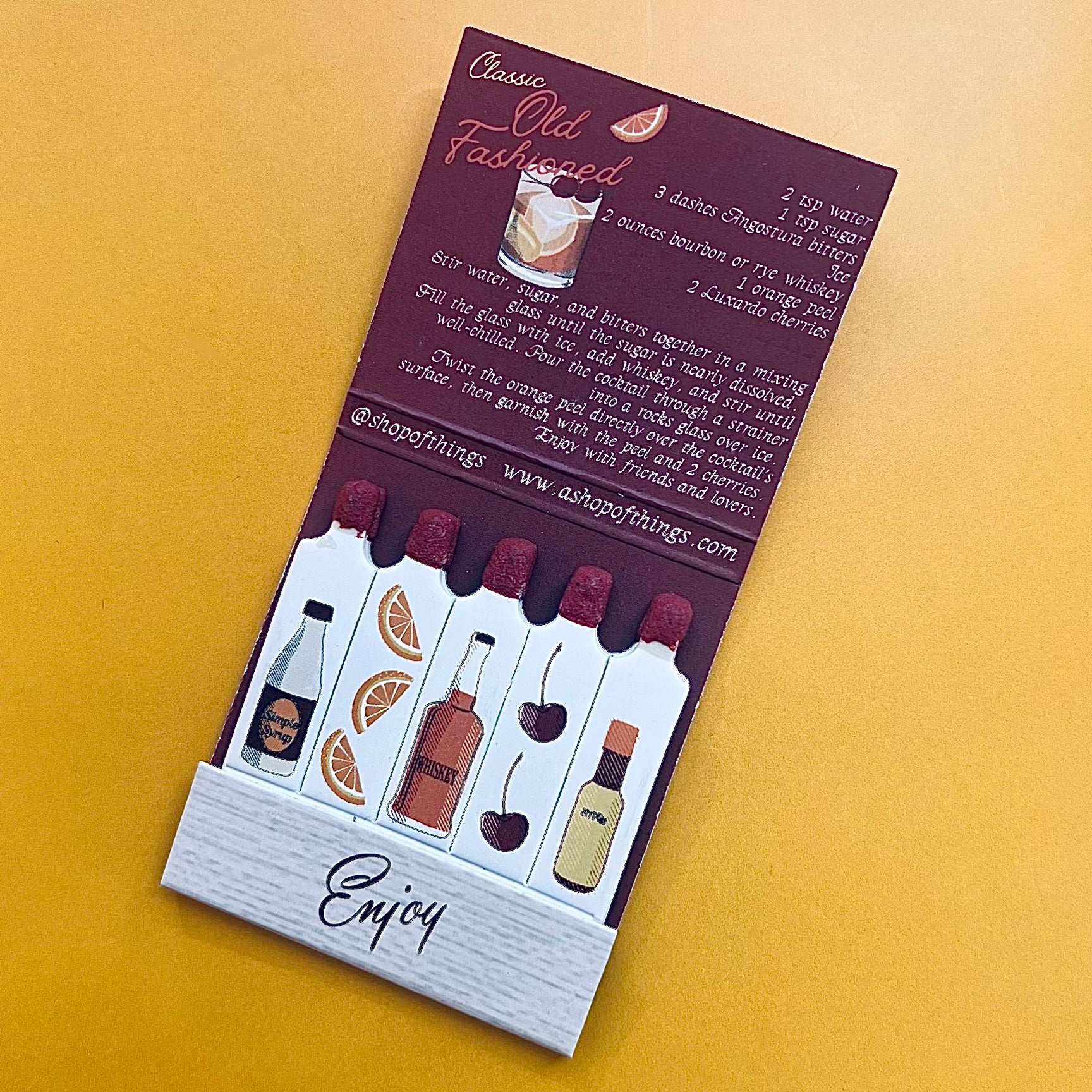 Inside of the Old Fashioned cocktail matchbook showing the recipe and individual matchsticks with drawings of the cocktail’s ingredients on each one