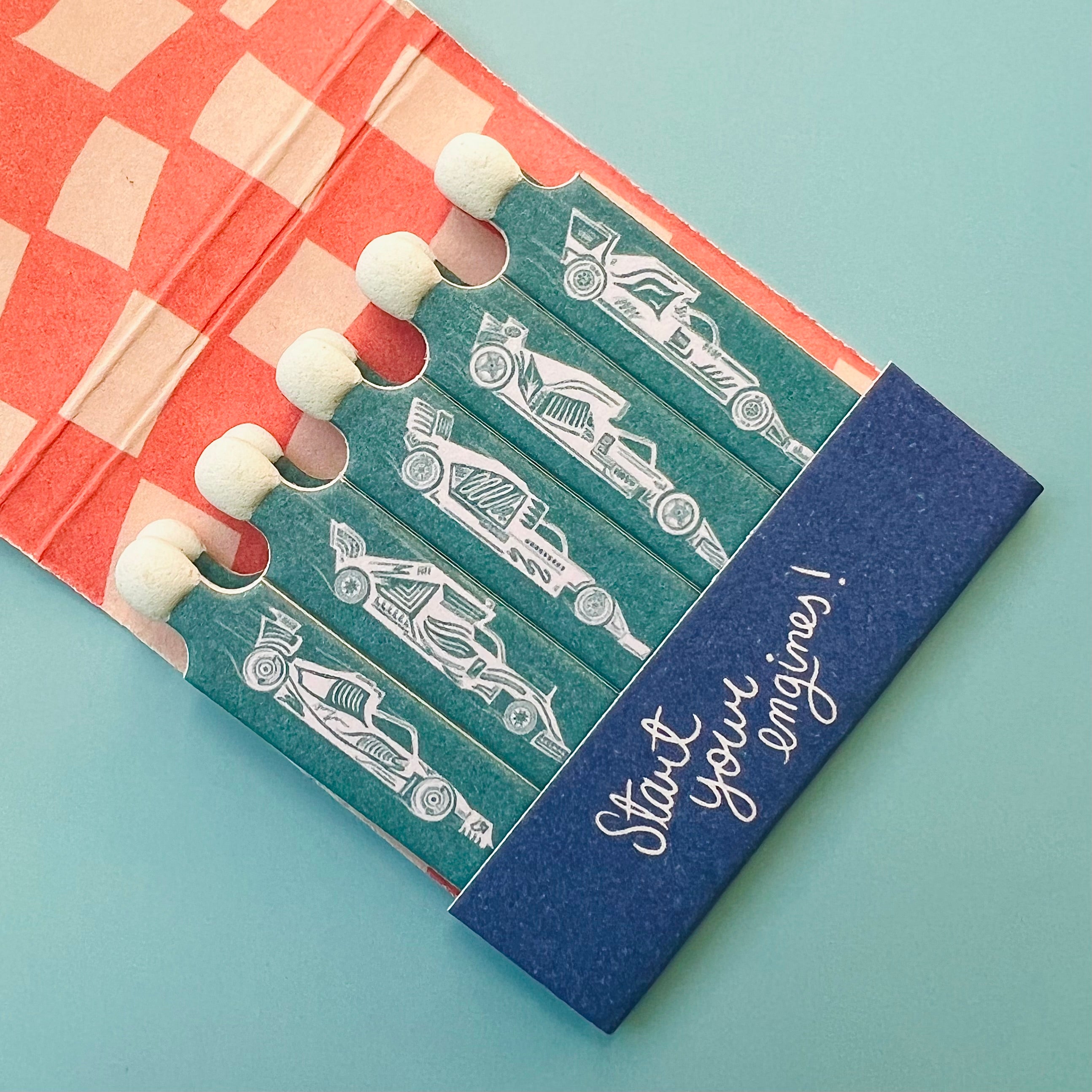 Close up of race car drawings on each individual matchstick